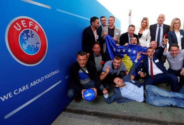 Members of the Kosovo media team celebrate outside the convention centre where the European football group UEFA admitted Kosovo as its newest member in Budapest, Hungary, May 3, 2016. REUTERS/Laszlo Balogh